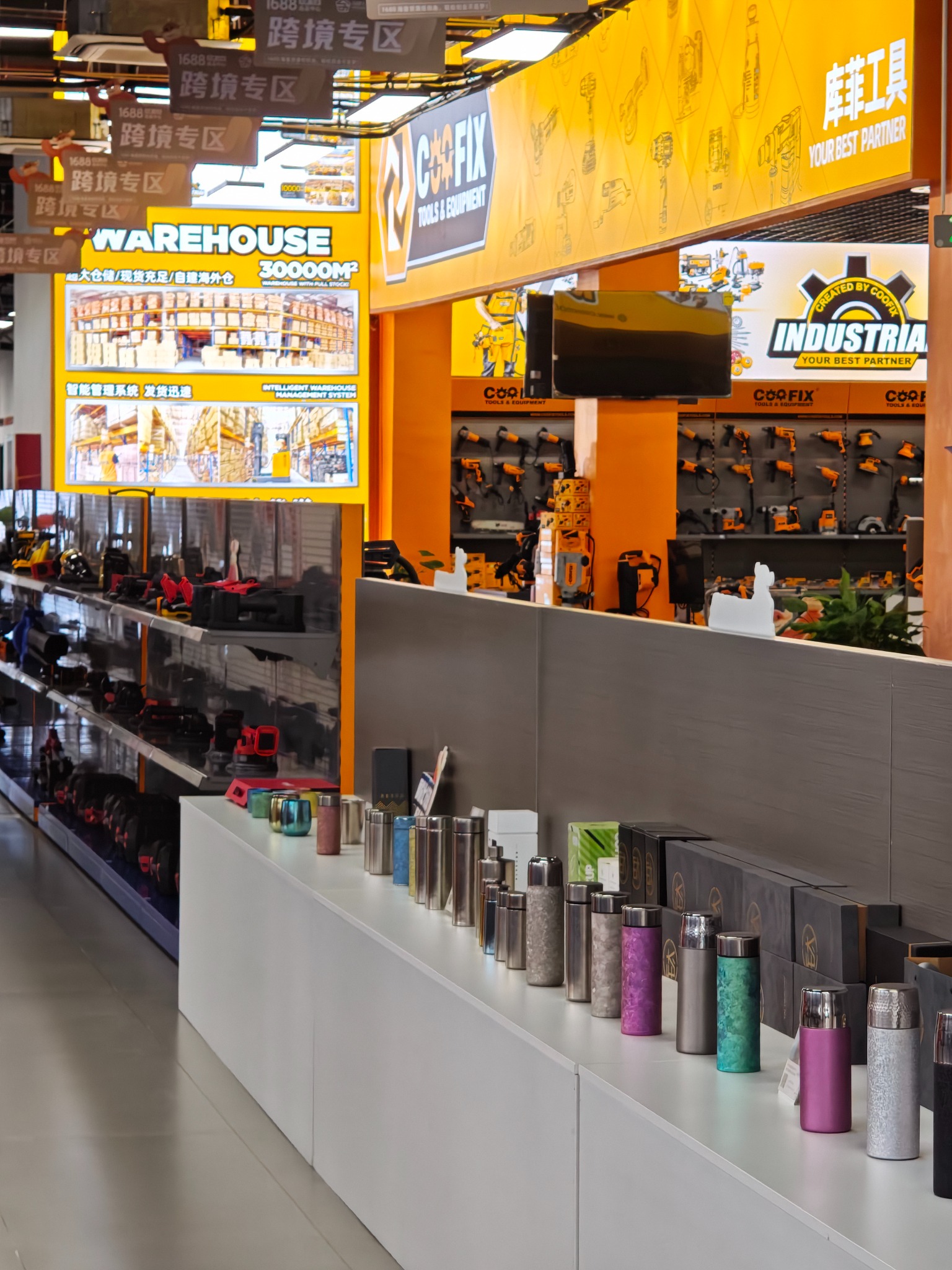 Real selection-center counter lined with metallic drinkware below an orange tool display